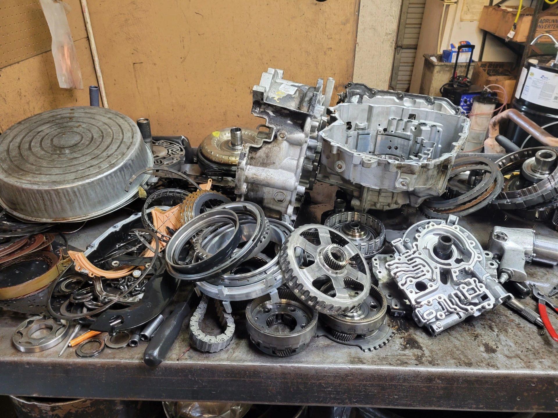 Disassembled transmission components on a workbench