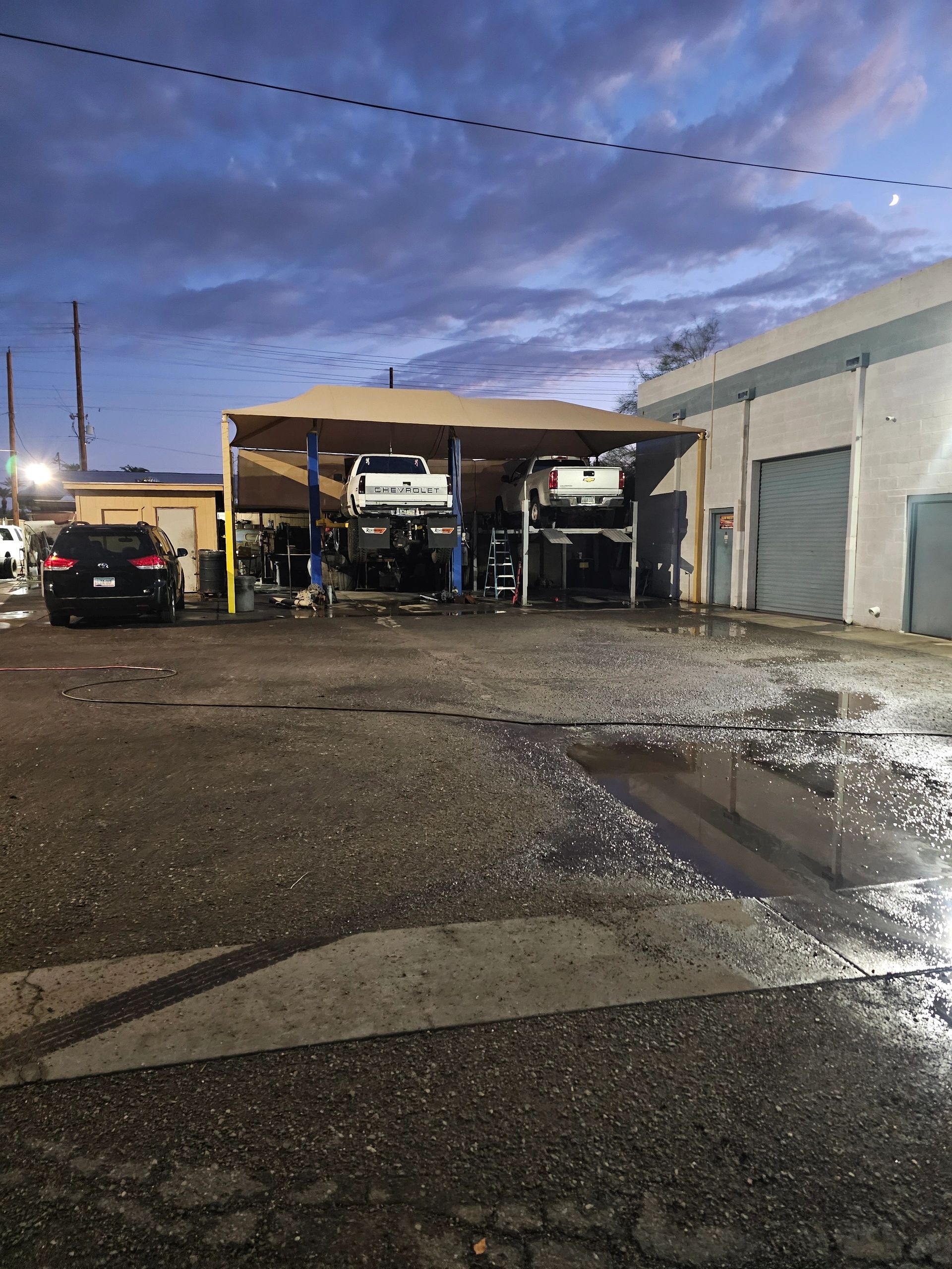 Automotive repair shop exterior at night